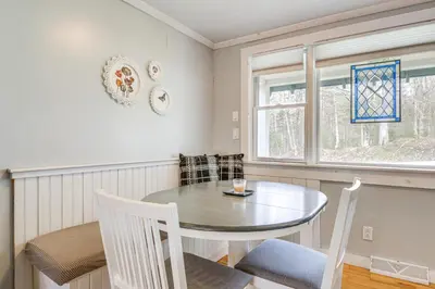 a dining room with a table and chairs and a window at 2 Mi to Mt Snow Cozy Family Alpine Retreat! in Wardsboro