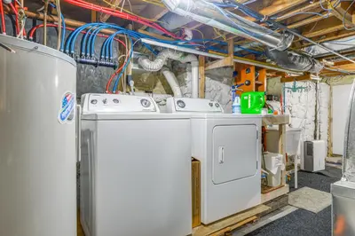 a laundry room with two washing machines in it at 2 Mi to Mt Snow Cozy Family Alpine Retreat! in Wardsboro