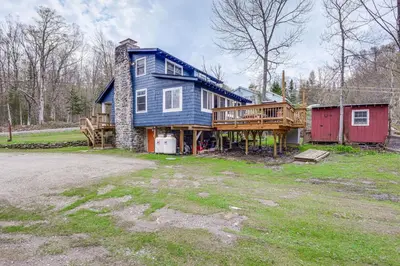 a large blue house with a porch and a deck at 2 Mi to Mt Snow Cozy Family Alpine Retreat! in Wardsboro