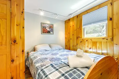 a bedroom with a bed and a window at 2 Mi to Mt Snow Cozy Family Alpine Retreat! in Wardsboro