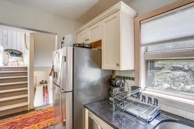 a kitchen with a stainless steel refrigerator and a window at Ski, Hike and More Year-Round Gem in Windham in Windham