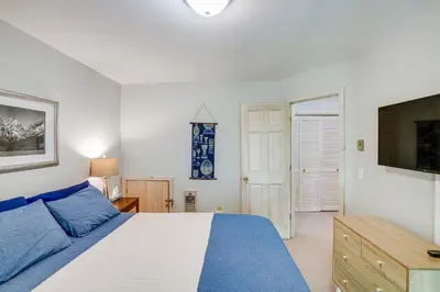a bedroom with a bed and a flat screen tv at Ski, Hike and More Year-Round Gem in Windham in Windham