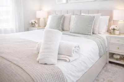 a white bedroom with towels on a bed at New Haven Staycation Near Yale Washer and Dryer Groups in New Haven