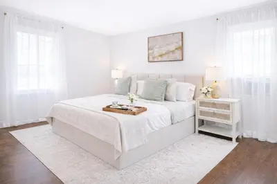 a white bedroom with a white bed and a table at New Haven Staycation Near Yale Washer and Dryer Groups in New Haven