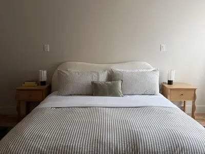 a bedroom with a bed with striped sheets and pillows at 3.8 Million Dollar Brownstone Newly Renovated in New York