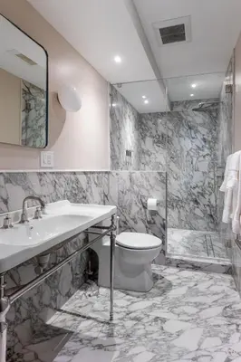 a bathroom with a toilet and a sink and a shower at 3.8 Million Dollar Brownstone Newly Renovated in New York