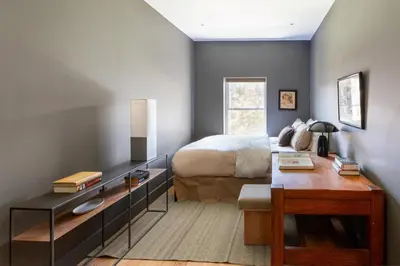 a bedroom with a bed and a desk at 3.8 Million Dollar Brownstone Newly Renovated in New York