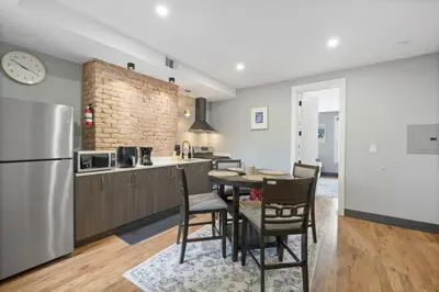 a kitchen and dining room with a table and chairs at Luxury and Chic 2BR 2BA Apt Mins to NYC and Hoboken in Jersey City