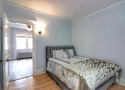 a bedroom with a bed with a black and white comforter at Cozy two bedroom home close to everything in Amsterdam