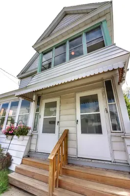 a house with white doors and a porch at Cozy two bedroom home close to everything in Amsterdam