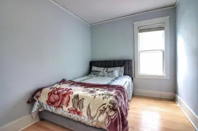a bedroom with a bed with a blanket on it at Cozy two bedroom home close to everything in Amsterdam