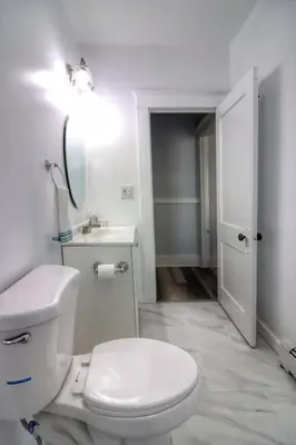 a white bathroom with a toilet and a sink at Cozy two bedroom home close to everything in Amsterdam