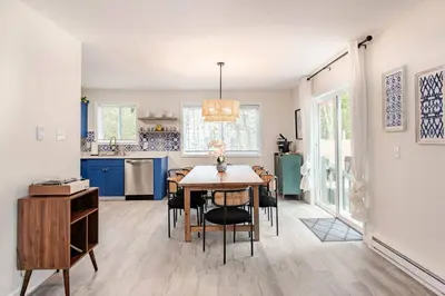 a kitchen and dining room with a table and chairs at Azure on the Pocono in Tobyhanna