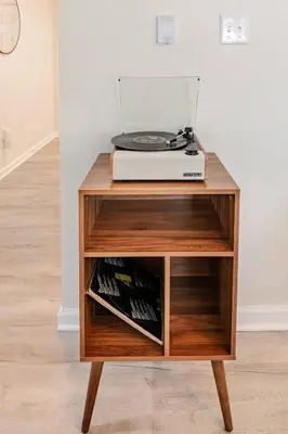 a wooden stand with a record player on top of it at Azure on the Pocono in Tobyhanna