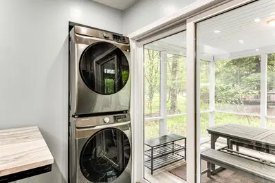 a washer and dryer in a room with a window at Less Than 2 Mi to Big Bass Lake Modern Mtn Chalet! in Gouldsboro