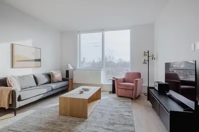 a living room with a couch and a coffee table at Blueground Jersey City EV charging nr park NYC-1690 in New York