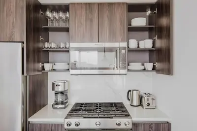a kitchen with a stove and a microwave at Blueground Jersey City EV charging nr park NYC-1690 in New York