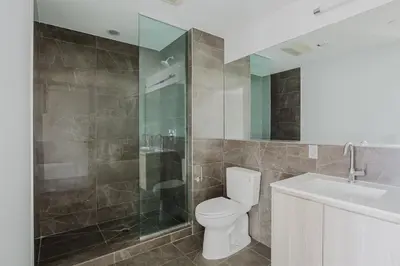 a bathroom with a toilet and a shower and a sink at Blueground Jersey City EV charging nr park NYC-1690 in New York