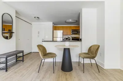 a kitchen and dining room with a table and chairs at Blueground LIC pool wd nr Gantry Park NYC-1845 in New York