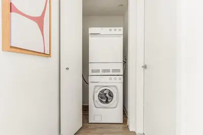 a laundry room with a washer and dryer at Blueground LIC pool wd nr Gantry Park NYC-1845 in New York