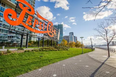 a large orange sign in front of a building at Blueground LIC pool wd nr Gantry Park NYC-1845 in New York