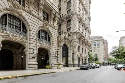 a large building with cars parked on a city street at Blueground Upper West Side fitness center nr Central Park NYC-1596 in New York