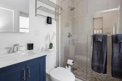 a bathroom with a shower and a toilet and a sink at Chic Studio Close to Harbor Point in Stamford