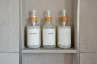 a group of four bottles sitting on a shelf at Chic Studio Close to Harbor Point in Stamford
