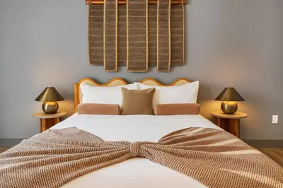 a bedroom with a bed with a bow tie on it at Modern and Harford Center 1-BR Near XLCenter and ConventionCenter in Hartford