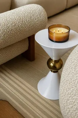 a candle on a white table next to a couch at Modern and Harford Center 1-BR Near XLCenter and ConventionCenter in Hartford