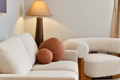 a living room with two balls on a chair at Modern and Harford Center 1-BR Near XLCenter and ConventionCenter in Hartford