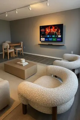 a living room with chairs and a tv on the wall at Modern and Harford Center 1-BR Near XLCenter and ConventionCenter in Hartford