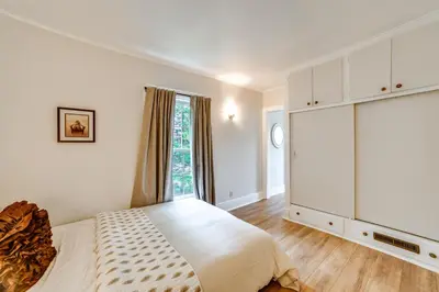 a white bedroom with a bed and a window at Hike and Baseball Near Cooperstown Home on 30 Acres in Westford