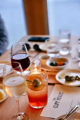 a table with two glasses of wine and plates of food at Prospect Berkshires in North Egremont