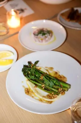 a plate of food with asparagus on a table at Prospect Berkshires in North Egremont
