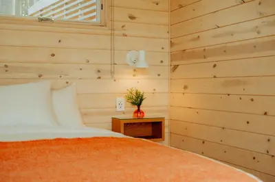 a bedroom with a bed and a vase on a table at Prospect Berkshires in North Egremont