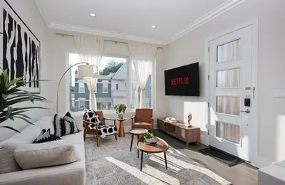 a living room with a couch and a table at Travelers Dream that's Mins to NYC having Game Room and Parking in Jersey City