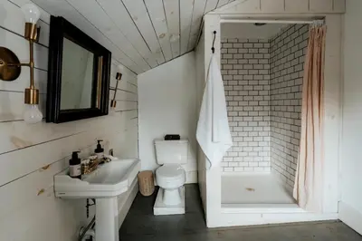 a bathroom with a sink and a toilet and a shower at Book Village Inn - Dickinson Room Queen Bed in Hobart