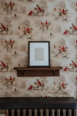 a wall with a painting of jockeys on horses on a wall at Book Village Inn - Twain Room Queen Bed in Hobart