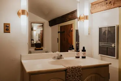 a bathroom with a sink and a mirror at Book Village Inn - Fitzgerald Room King Bed in Hobart