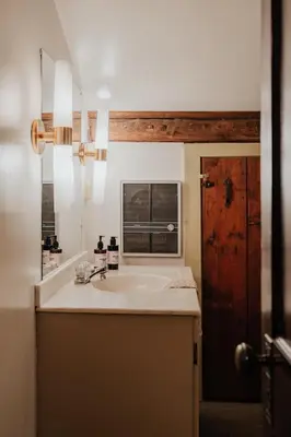 a bathroom with a sink and a window at Book Village Inn - Fitzgerald Room King Bed in Hobart