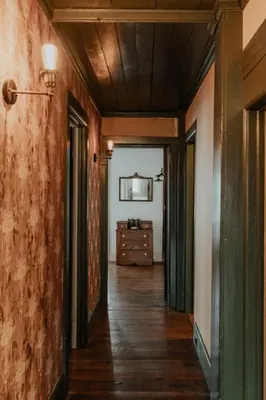 an empty hallway with a dresser in a room at Book Village Inn - Fitzgerald Room King Bed in Hobart