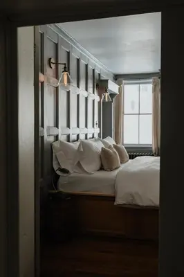 a bedroom with a large bed with a window at Book Village Inn - Entire Hotel in Hobart