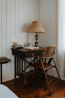 a wooden desk with a lamp and a chair at Book Village Inn - Entire Hotel in Hobart
