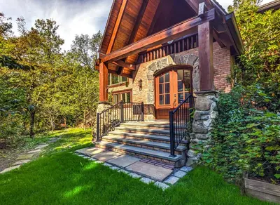 a stone house with stairs leading to the front door at Mountain Lodge Retreat, Near New Paltz & Hikes in New Paltz