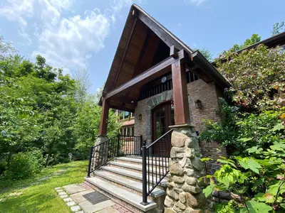 a small brick house with stairs and a porch at Mountain Lodge Retreat, Near New Paltz & Hikes in New Paltz