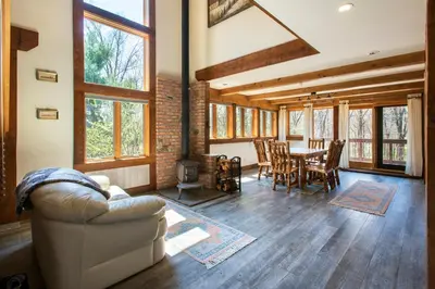 a living room with a couch and a table at Mountain Lodge Retreat, Near New Paltz & Hikes in New Paltz