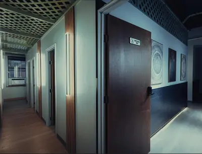 a hallway with a wooden door in a room at CityNest Hotel in New York