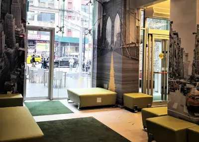 a lobby with couches and tables in a building at Holiday Inn New York City - Times Square by IHG in New York