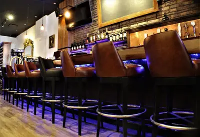a bar with brown leather seats in a restaurant at Holiday Inn New York City - Times Square by IHG in New York